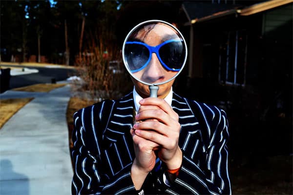 guy behind magnifying glass