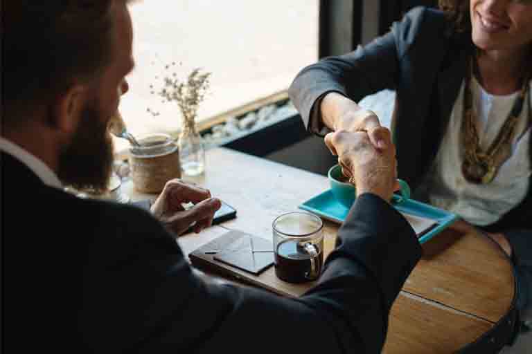 a female interviewer shaking the hand of her interviewee after the oracle interview