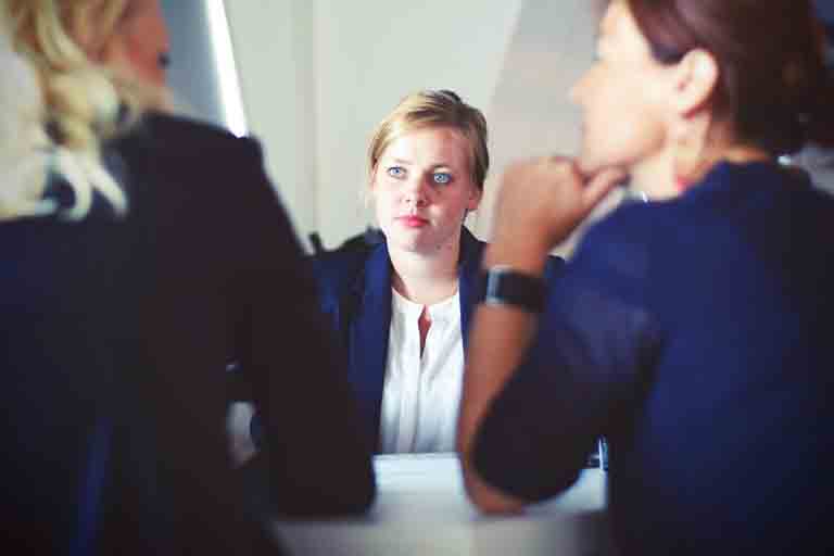 a woman going through oracle interview questions being asked by a panel