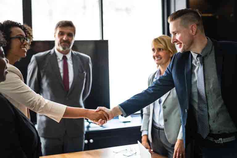 a female interviewee shaking hands with one of the interviewer