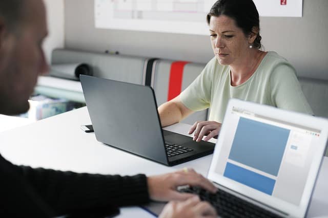 Two person using a laptop computer