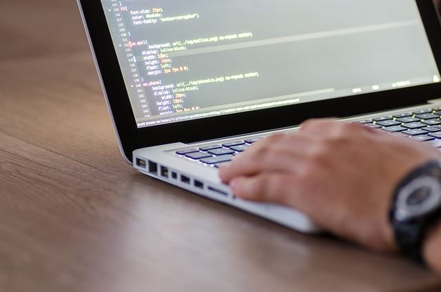 Man coding a javascript program on his computer